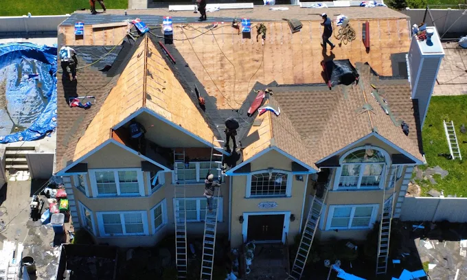 Greene Group Construction roofing crew replacing a roof on a Long Island home